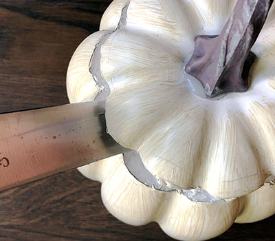 cutting a faux pumpkin