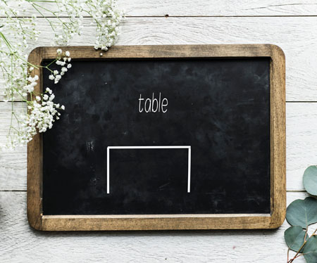 Chalkboard with stick figure table