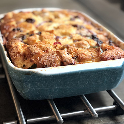 Christmas Breakfast Strata Baked in a blue casserole dish