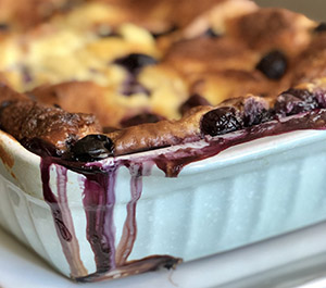 Christmas Breakfast Sugar Plum Toast baked in casserole dish with overflowing blueberries