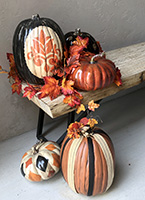 porch bench with decorated pumpkins