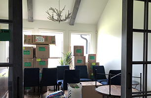 Moving boxes in a room with furniture