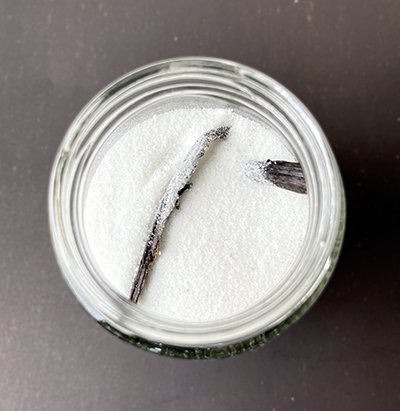 sugar in a jar with pods of vanilla